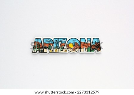 Colourful PVC souvenir fridge magnet of Arizona, USA on white background. Travel memory concept. Gift typical product for tourists from foreign trip. Home decoration. Top view, flat lay, close up