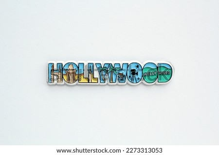 Colourful PVC souvenir fridge magnet of Hollywood, USA on white background. Travel memory concept. Gift typical product for tourists from foreign trip. Home decoration. Top view, flat lay, close up