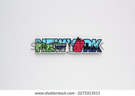 Colourful PVC souvenir fridge magnet of New York, USA on white background. Travel memory concept. Gift typical product for tourists from foreign trip. Home decoration. Top view, flat lay, close up