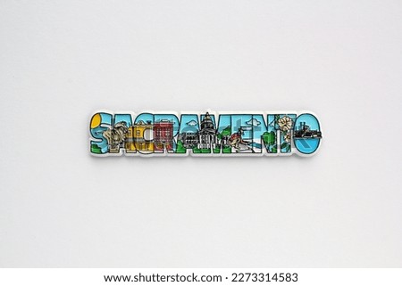 Colourful PVC souvenir fridge magnet of Sacramento, USA on white background. Travel memory concept. Gift typical product for tourists from foreign trip. Home decoration. Top view, flat lay, close up