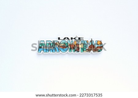 Colorful PVC souvenir fridge magnet of Lake Arrowhead, USA on white background. Travel memory concept. Gift typical product for tourists from foreign trip. Home decoration. Top view, flatlay, close up