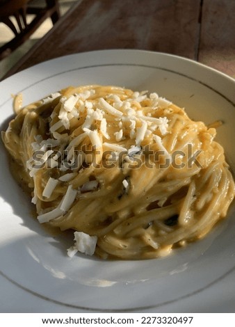 Spaghetti with pumkin sauce to celebrating a hallloween. Picture of home made pasta with pumkin sauce