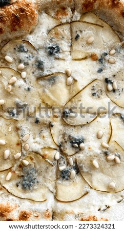 pizza with gorgonzola pears with pine nuts in Italian. Close up vertical photo