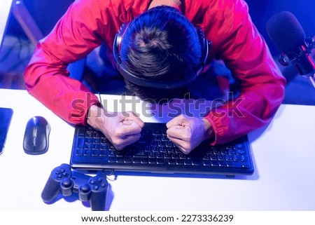 Angry gamer man destroy keyboard. Playing computer pc. He lose in the game. Missed the chance to become a champion in tournament. Unhappy upset Indian streaming video game online and lost.