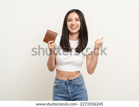 Young beautiful asian woman with brown wallet on isolated white background. Financial and investment concept. Business asian woman counting money in wallet. Royalty-Free Stock Photo #2273336245