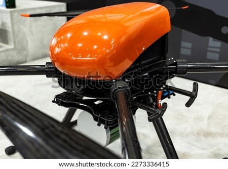 specialized industrial drone with red body with suspension close-up, selective focus, depth of field.