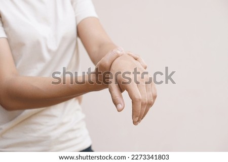 woman has muscle weakness in her hand Royalty-Free Stock Photo #2273341803