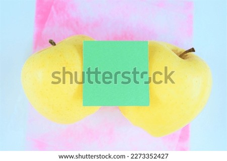 Mock-up of two golden apples and cute comment space on white background with pink washi paper