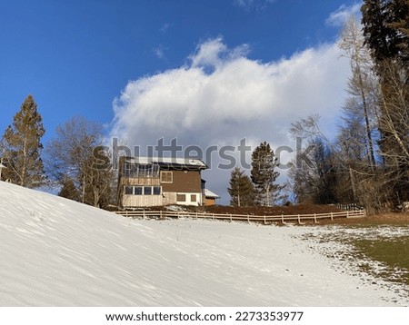 Traditional Swiss architecture and wooden alpine houses in the winter ambience of fresh white snow cover, Unterwasser - Obertoggenburg, Switzerland (Schweiz)