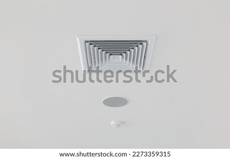 White ceiling ventilation grille with rectangular diffuser and smoke catch. close up photo