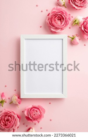 Women's Day concept. Top view vertical photo of photo frame pink peony roses and sprinkles on isolated pastel pink background with copyspace