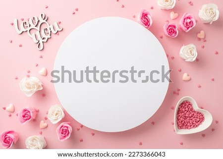 Mother's Day celebration concept. Top view photo of white circle small roses inscription love you and heart shaped saucer with sprinkles on isolated pastel pink background with copyspace