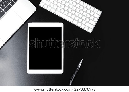 Top view of office table with technology gadget. Mock up black display screen digital tablet for advertise copy space. Modern lifestyles with internet flat lay angle concept.