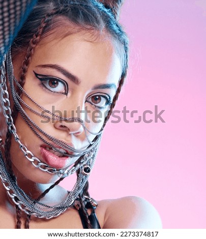 Chains, style and portrait of goth woman with unique fashion isolated against a studio pink background. Face, accessories and edgy female model metal jewelry on her head and cool makeup