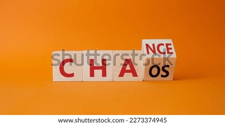 Chance vs Chaos symbol. Turned wooden cubes with words Chaos and Chance. Beautiful orange background. Psychology and Chance vs Chaos concept. Copy space