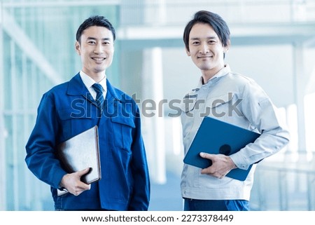 Two Japanese men wearing work clothes Royalty-Free Stock Photo #2273378449