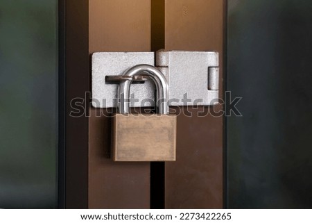 padlock  or door lock key Type for use with door-hasp ,Made of strong metal, locks firmly Prevents tampering from thieves.soft and selective focus.                                Royalty-Free Stock Photo #2273422265