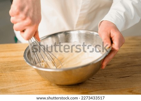 Professional kitchen chef prepares pancake Royalty-Free Stock Photo #2273433517