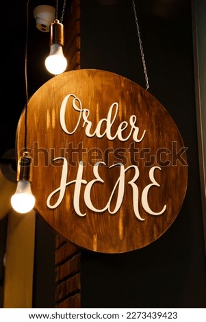 Restaurant service sign Order Here in modern loft style. Can be used in coffee shops, cafes, fast food restaurants