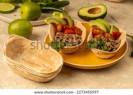 Mexican Feast Served Family Style - preparing Mexican food step by step -green  lemon avocados salt and cherry tomato 