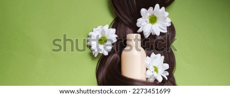 sustainable and cruelty-free products nourish and revitalize your hair and scalp, leaving you with healthy, radiant locks. Nature's beauty of hair adorned with ferns and daisies. Royalty-Free Stock Photo #2273451699