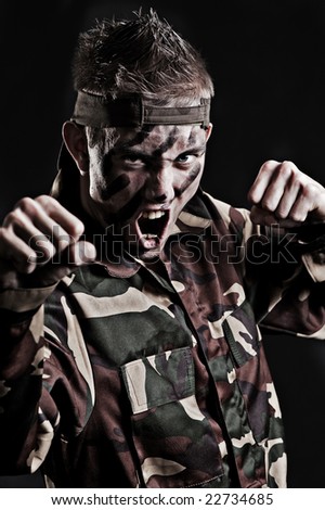 expressive young soldier over black background