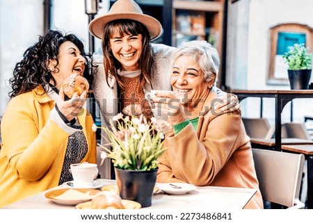 Group of happy elderly women having fun during breakfast in a cafeteria - Three retired female friends drinking coffee and cappuccino and eating croissant at bar - Mature female life style concept Royalty-Free Stock Photo #2273486841