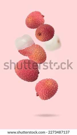 Isolated exotic fruit. Lychee fruits falling down with clipping path as package design element. Full depth of field. Food levitation concept. Pink background. Royalty-Free Stock Photo #2273487137