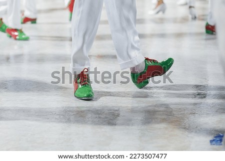samba dancer with white pants and red and green shoes performing in Rio de Janeiro, Brazil.