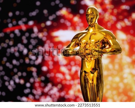 Hollywood Golden Oscar Academy award statue on firework background with copy space. Success and victory concept.