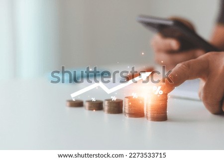 Interest rate and dividend concept, Business people calculate income and return on investment in percentages. stock market, investment, dividend tax, income, return, retirement, and compensation fund. Royalty-Free Stock Photo #2273533715