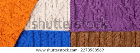 Knitted blue, lilac, brown, orange and beige background. Large knitted fabric with a pattern. Close-up of a knitted blanket. Banner