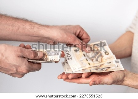 Hands of a man and a woman exchanging money. Banknotes on a white background. Counting money.
