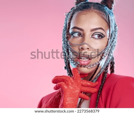 Chains, rock and goth fashion by woman with unique style isolated against a studio pink background. Creative, accessories and edgy female model metal jewelry on her head and cool makeup