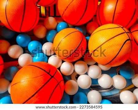 a photo of lots of basketballs in a toy basket