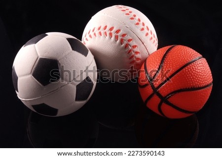 Three sports ball being isolated in black.