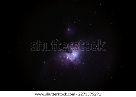 Night sky background with bright Orion nebula on black sky with stars. Astro photo on winter night with soft selective focus