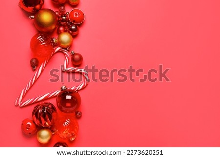 Christmas balls with candy canes on red background