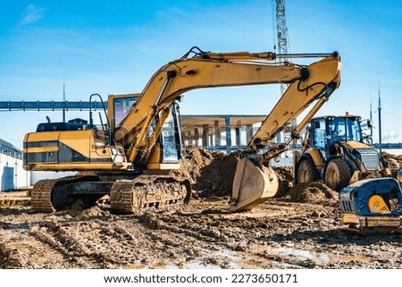 Yellow crawler excavator at the construction site. Earthworks at a construction site. Modern earthmoving equipment