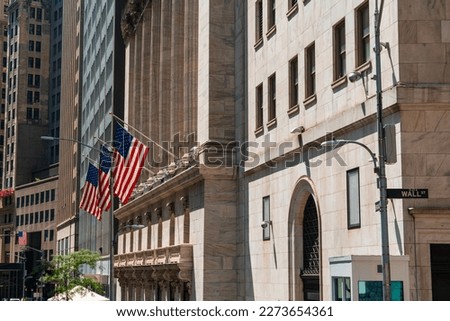 New York Wall street, stock exchange building and american flags. Concept of money and international banking system