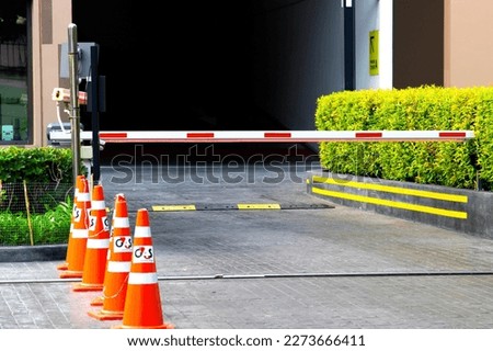 security system for building access - barrier gate stop with toll booth, traffic cones and cctv.