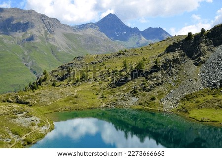 Mountain lake Lago di Loie in National park Gran Paradiso, Lillaz, Cogne, Aosta valley, Italy. Summer landscape in the Alps. Royalty-Free Stock Photo #2273666663