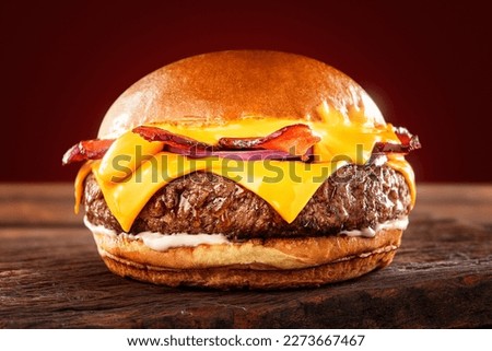 big burger with cheddar cream and sliced ​​cheddar with bacon and sliced ​​red onion Royalty-Free Stock Photo #2273667467