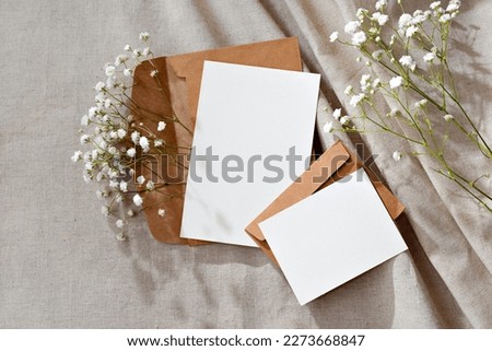 Aesthetic floral business brand template, blank paper cards and envelopes on a neutral beige background, mockup with copy space