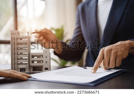 Considering buying a home, investing in real estate. Broker signs a sales agreement. agent, lease agreement, successful deal. Royalty-Free Stock Photo #2273686671