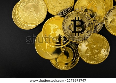 Gold Bitcoin and other Crypto Currency Coins Lying On a Black Background