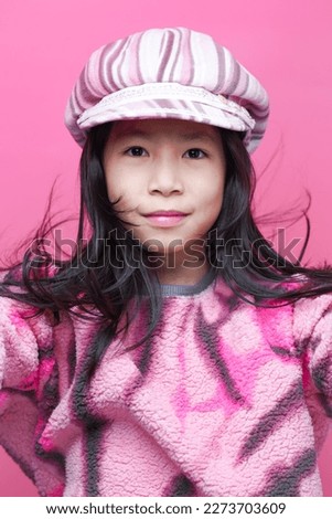 Beautiful little girl in pink sweater.