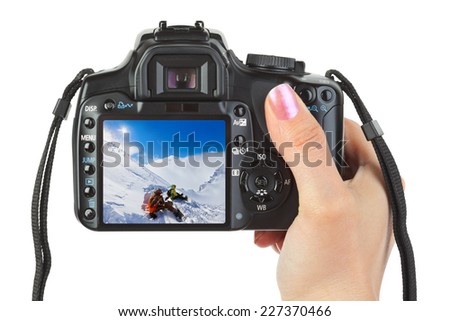 Camera in hand and winter Austria view (my photo) isolated on white background