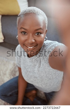 Portrait, black woman and selfie in home, smile and living room for social media, relax and live streaming. Face of happy female influencer, profile picture and video call in house, lounge or vlogger