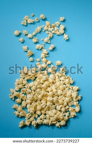 Bowls full of popcorn standing on colorful floor.